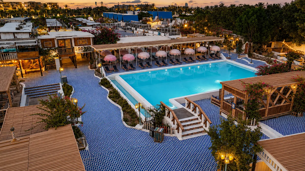 Aerial dusk view of the main pool with resort lights