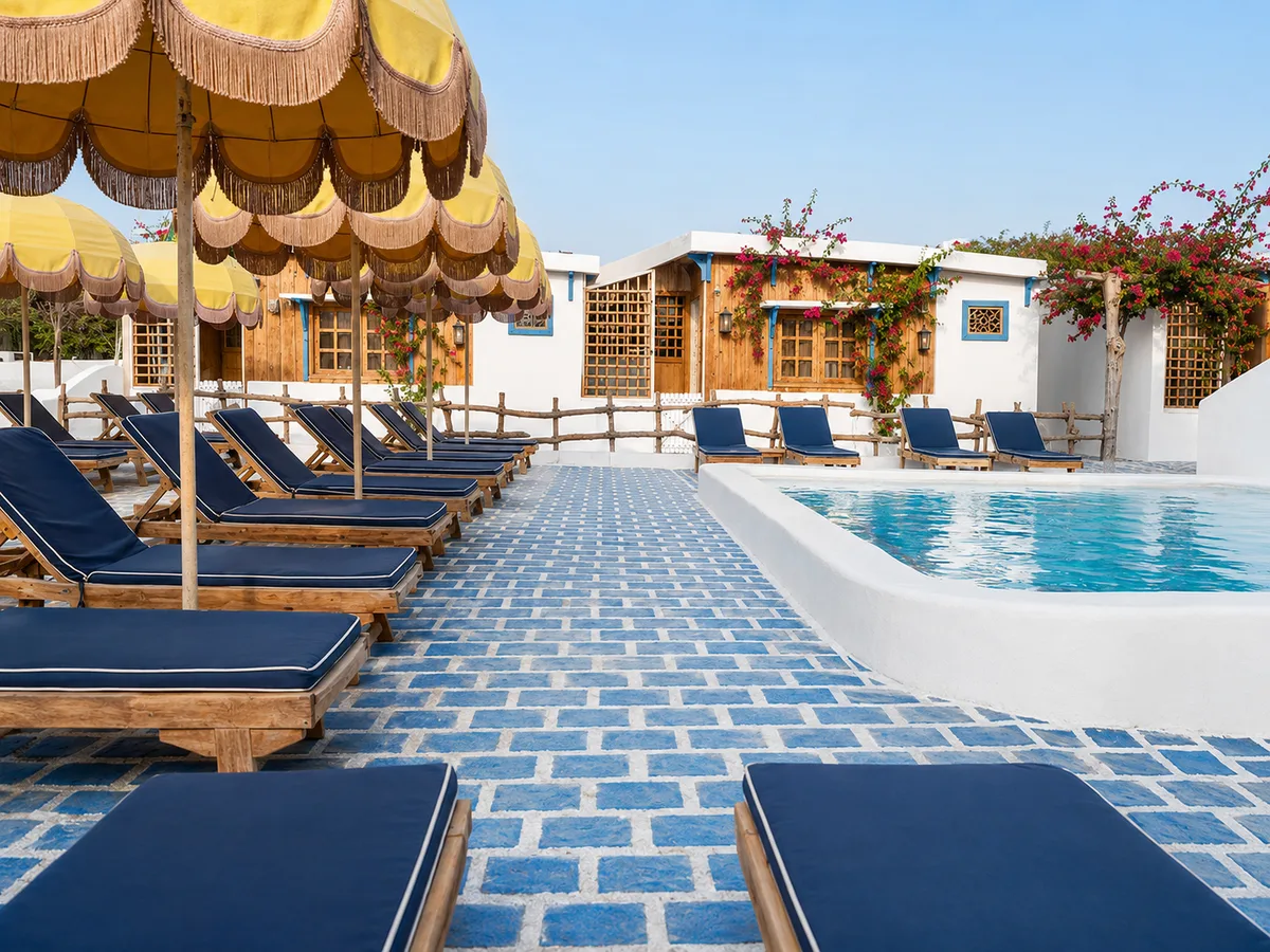 Pool deck with yellow umbrella fringe and white Banan Beach rooms